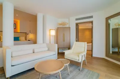a living room with a couch and a table and chairs at Grand Bavaro Princess - All Inclusive in Punta Cana
