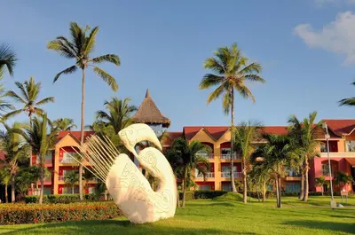 a large sculpture in front of a resort with palm trees at Punta Cana Princess Adults Only - All Inclusive in Punta Cana