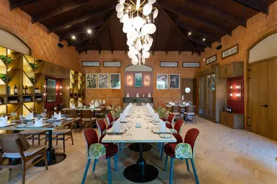 a dining room with tables and chairs and a chandelier at Caribe Deluxe Princess - All Inclusive in Punta Cana