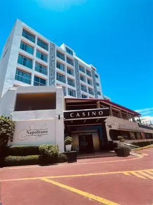 a large apartment building with a parking lot in front of it at Napolitano Hotel in Santo Domingo
