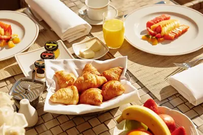 a table topped with plates of food and fruit at El Embajador, a Royal Hideaway Hotel in Santo Domingo