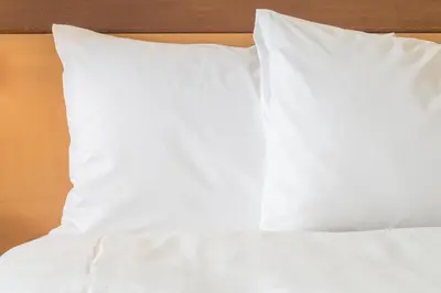 a stack of white pillows on a bed at Holiday Inn Santo Domingo by IHG in Santo Domingo