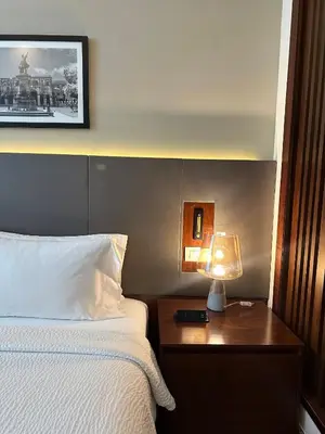 a hotel room with a bed and a lamp on a table at Holiday Inn Santo Domingo by IHG in Santo Domingo
