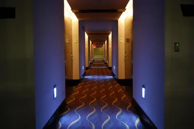a hallway with purple walls and a long corridor at Holiday Inn Santo Domingo by IHG in Santo Domingo