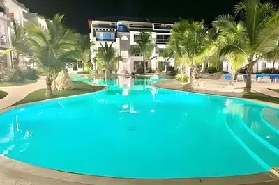 a large pool with blue water in front of a building at Estrella Dominicus Advantage in Bayahibe