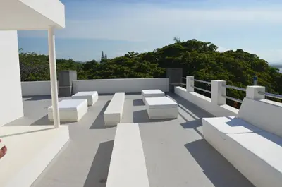 a group of white benches sitting on top of a roof at CASA-22 Luxury Boutique Hotel in Sosúa