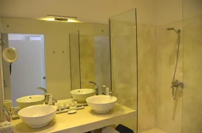 a bathroom with two sinks and a shower at CASA-22 Luxury Boutique Hotel in Sosúa