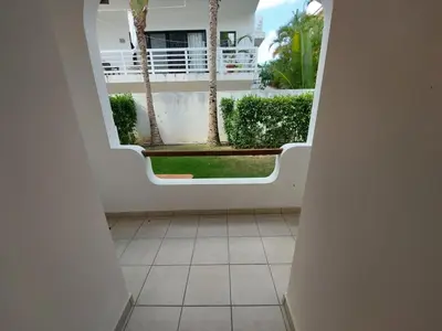 a hallway with a view of a courtyard with palm trees at Tamarindo in Bayahibe