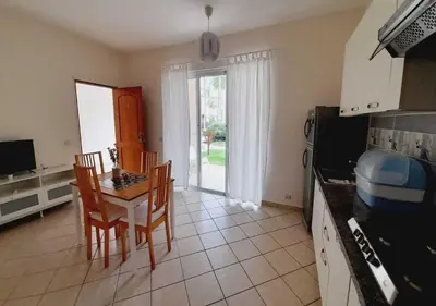 a kitchen with a table and chairs and a dining room at Tamarindo in Bayahibe