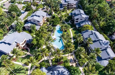 an aerial view of a resort with a pool and palm trees at Hotel Alisei in Las Terrenas