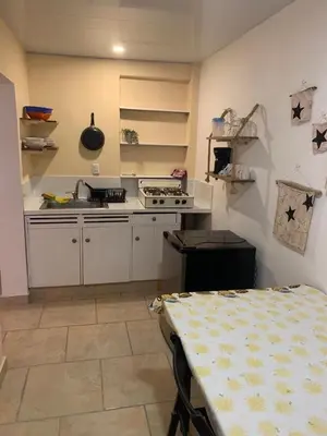 a kitchen with a sink and a table in it at Villa Mar Sosua in Sosúa