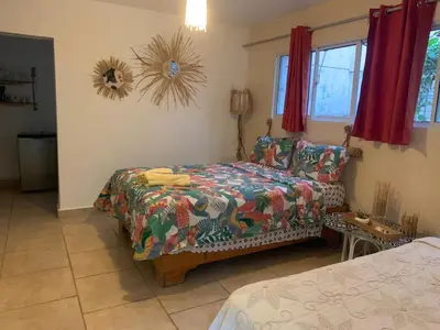 a bedroom with a bed and a couch at Villa Mar Sosua in Sosúa