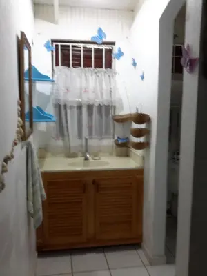 a bathroom with a sink and a shower curtain at Villa Mar Sosua in Sosúa