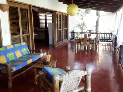 a living room with a couch and chairs and a table at Villa Mar Sosua in Sosúa