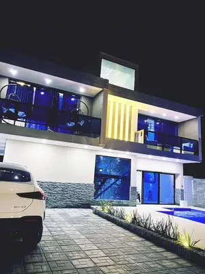 a white car parked in front of a house at Villa Elegante y Familiar en Pedernales, Cerca de la Playa del pueblo, Residencial SFA in Pedernales