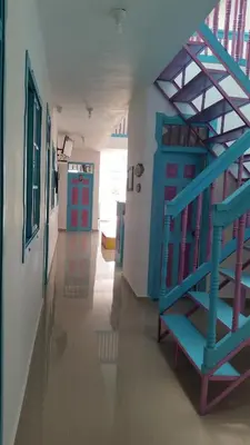 a staircase in a hallway with blue and red doors at Hostal Johnnier Macao Punta Cana in Punta Cana