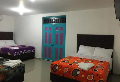a bedroom with a bed and a blue door at Hostal Johnnier Macao Punta Cana in Punta Cana