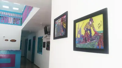 a hallway with paintings on the walls of a building at Hostal Johnnier Macao Punta Cana in Punta Cana