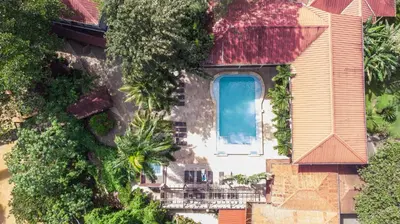 an aerial view of a house with a swimming pool at Hotel Gran Jimenoa in Jarabacoa