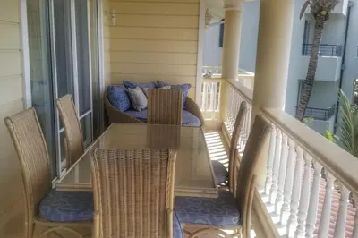 a table and chairs on a porch with a couch at Ocean Front Two Bedroom Penthouse in Sosúa