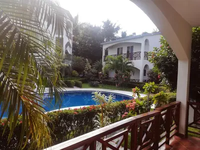 a view from the balcony of a house with a swimming pool at Apartamento en Las Terrenas in Las Terrenas