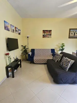 a living room with a couch and a tv at Apartamento en Las Terrenas in Las Terrenas