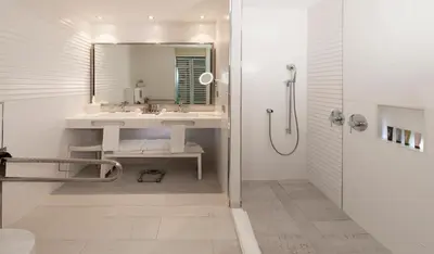 a white bathroom with a sink and a shower at Catalonia Royal La Romana Adults Only - All Inclusive in Bayahibe