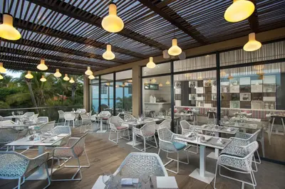a restaurant with tables and chairs and lights at Catalonia Royal La Romana Adults Only - All Inclusive in Bayahibe