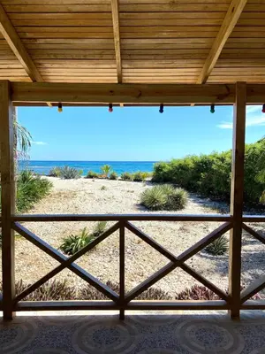 a view of the beach from the porch of a house at Hotel Al Mare in Santa Cruz de Barahona