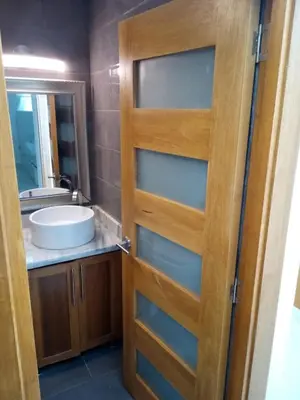 a door to a bathroom with a sink and a mirror at White House Mansion in San Felipe de Puerto Plata
