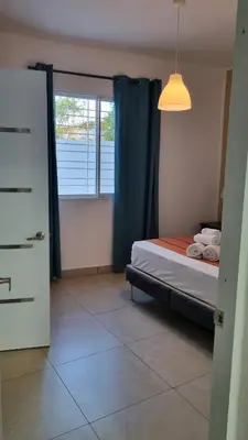 a bedroom with a bed and a window at Villa Roberta in Boca Chica