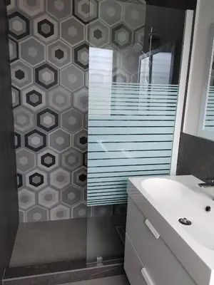 a bathroom with a shower with a sink and a mirror at Villa Roberta in Boca Chica