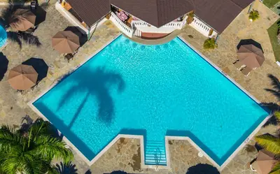 an overhead view of a swimming pool with umbrellas at Lifestyle Crown Residence Suites in San Felipe de Puerto Plata