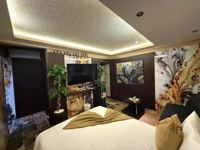 a bedroom with a bed and a flat screen tv at Sosua Inn Hotel in Sosúa