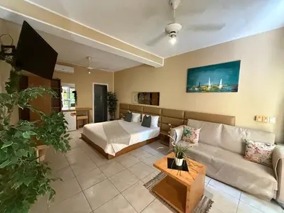 a living room with a bed and a couch at Sosua Inn Hotel in Sosúa