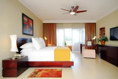 a hotel room with a bed and a window at Presidential Suites by Lifestyle Puerto Plata - All Inclusive in San Felipe de Puerto Plata