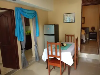 a kitchen with a table and a refrigerator at The Boat House in Boca Chica