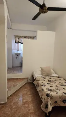 a bedroom with a bed and a ceiling fan at The Boat House in Boca Chica