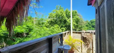 a balcony with a view of trees and bushes at Tropic ecolodge in Punta Rucia