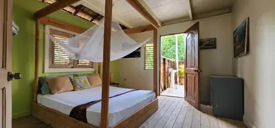 a bedroom with a canopy bed in a room at Tropic ecolodge in Punta Rucia