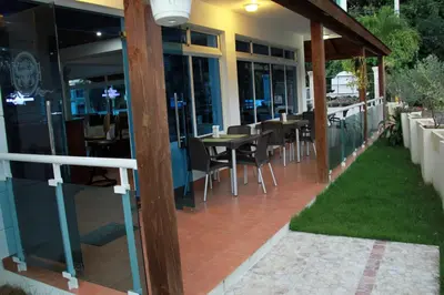 a restaurant with a patio with tables and chairs at Anton Reef in Sosúa
