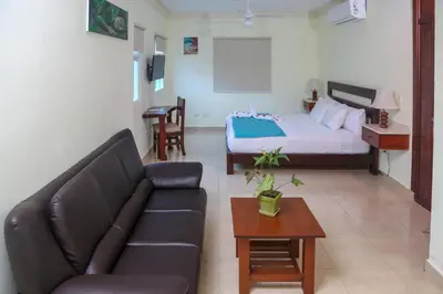 a living room with a couch and a bed at Anton Reef in Sosúa