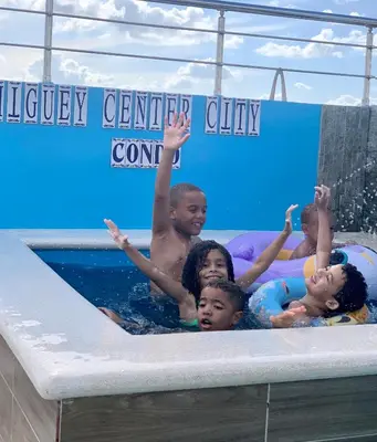 a group of children in a pool at a water park at Higuey Center City in Higuey