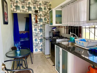 a kitchen with a sink and a table in it at Higuey Center City in Higuey
