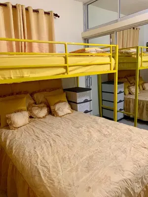 two bunk beds in a room with a bed at Higuey Center City in Higuey