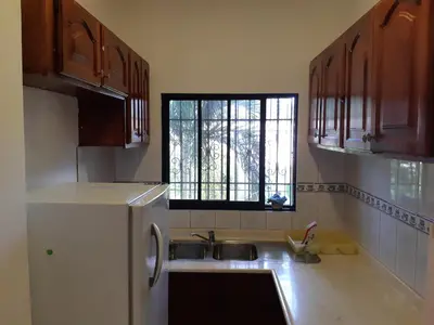 a kitchen with a sink and a window at Caleton Group in Río San Juan