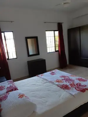a bedroom with a large bed with flowers on it at Caleton Group in Río San Juan