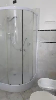 a bathroom with a shower and a toilet at Villa Florencia in Boca Chica