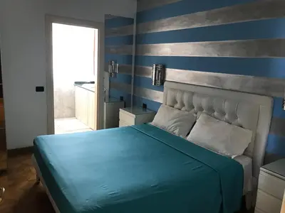 a bedroom with a blue and gray striped wall at Villa Florencia in Boca Chica