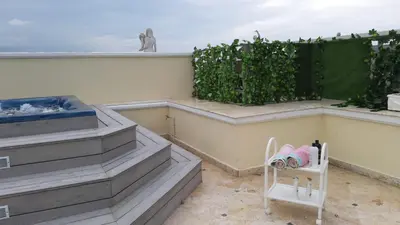 a small white chair sitting on a balcony at Villa Florencia in Boca Chica